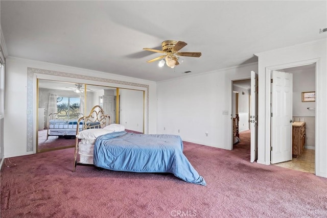 carpeted bedroom with connected bathroom, ornamental molding, a closet, and ceiling fan