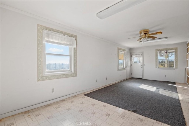 unfurnished room featuring ornamental molding and ceiling fan