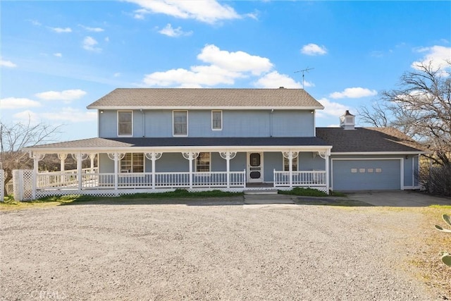 farmhouse with a porch and a garage