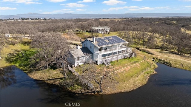 drone / aerial view with a water and mountain view