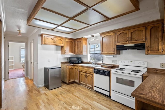 kitchen with crown molding, white appliances, light hardwood / wood-style floors, and sink