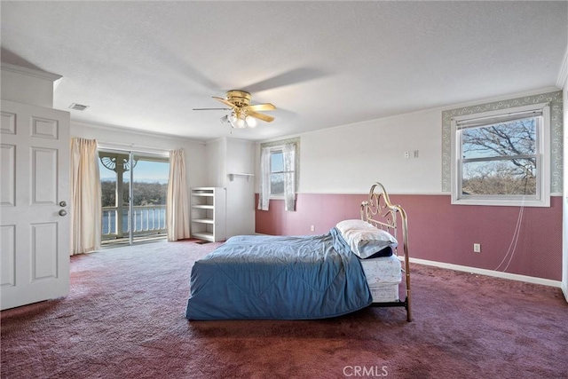 carpeted bedroom featuring ceiling fan, ornamental molding, and access to outside