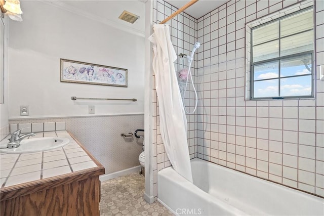 full bathroom with vanity, ornamental molding, shower / tub combo with curtain, and toilet