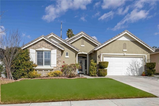 view of front facade with a garage and a front lawn