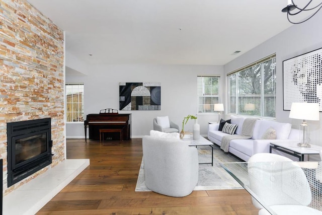 living room with a fireplace and dark hardwood / wood-style flooring