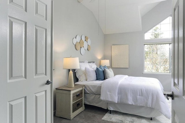 carpeted bedroom featuring high vaulted ceiling