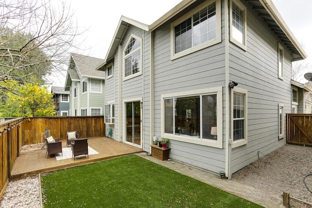 rear view of property featuring a patio and a lawn