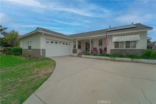 ranch-style house with a front yard, solar panels, covered porch, a garage, and stone siding