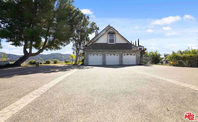 view of front facade featuring a mountain view and a garage