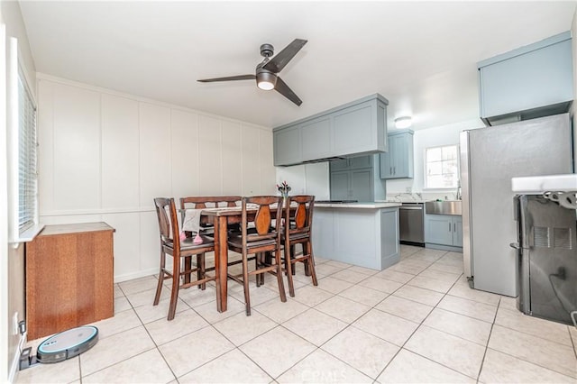 tiled dining space with ceiling fan