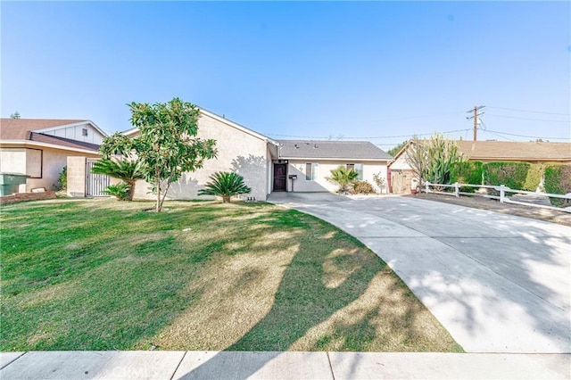 ranch-style home with a front lawn