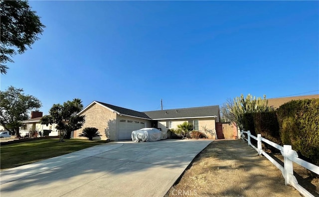 ranch-style house featuring a garage and a front yard