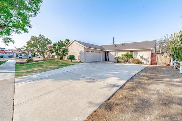 ranch-style home featuring a garage and a front lawn