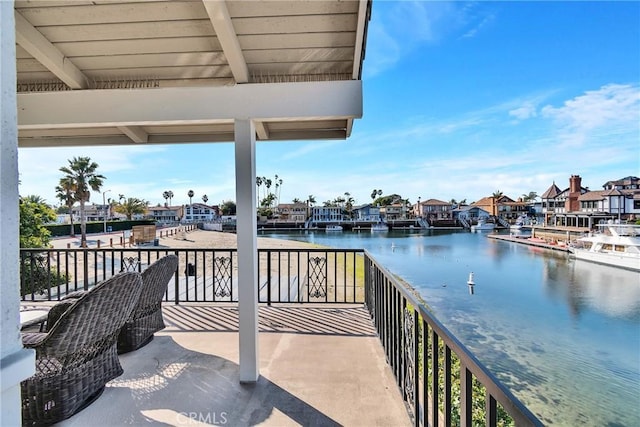 view of patio / terrace featuring a balcony and a water view