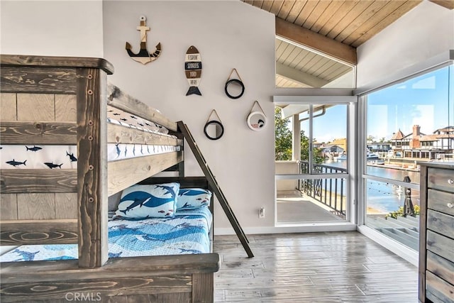 bedroom featuring access to exterior, a water view, wood-type flooring, lofted ceiling with beams, and wooden ceiling