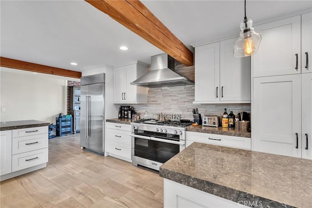 kitchen with pendant lighting, white cabinetry, premium appliances, beamed ceiling, and wall chimney range hood