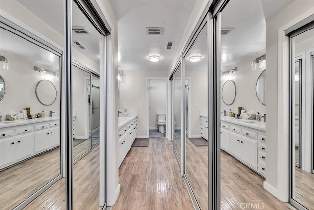 bathroom featuring vanity, toilet, and hardwood / wood-style floors