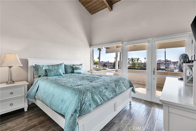 bedroom with dark wood-type flooring, lofted ceiling with beams, and access to outside