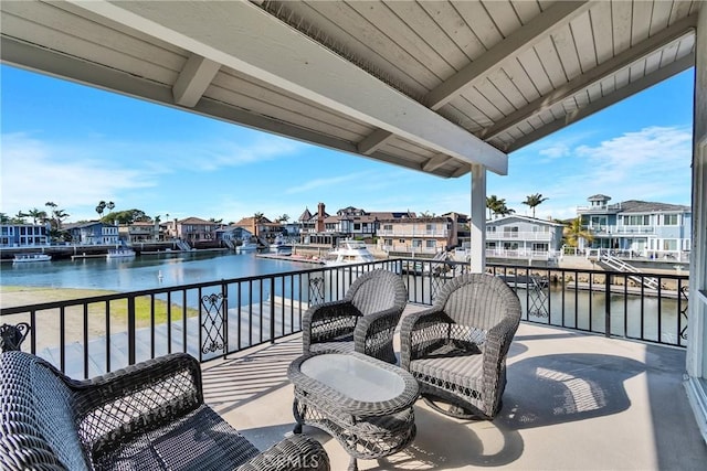 view of patio / terrace featuring a water view and a balcony