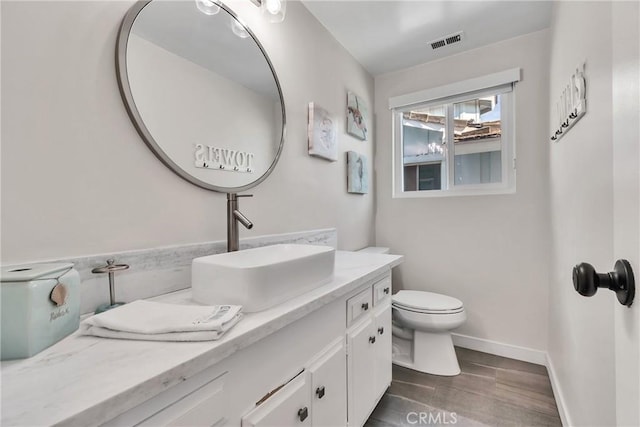 bathroom with vanity and toilet