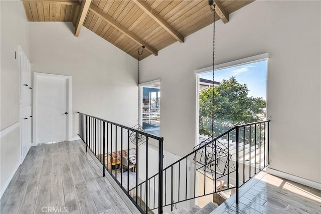 hall with high vaulted ceiling, hardwood / wood-style floors, wood ceiling, and beam ceiling