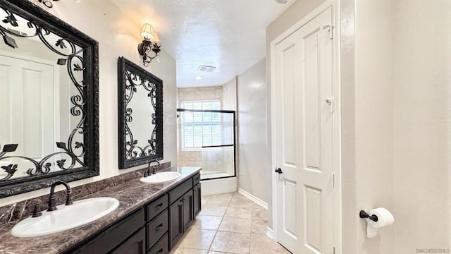 bathroom featuring vanity, combined bath / shower with glass door, and tile patterned floors