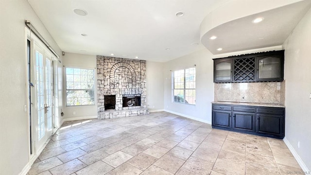 unfurnished living room featuring a fireplace and a wealth of natural light