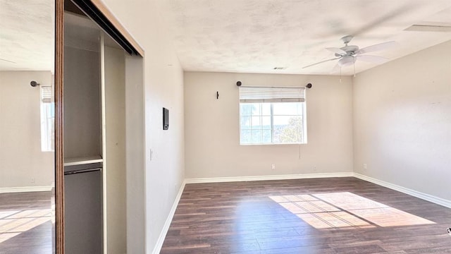 unfurnished room featuring ceiling fan and dark hardwood / wood-style floors