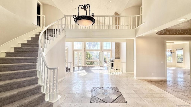 entrance foyer with a towering ceiling and a chandelier