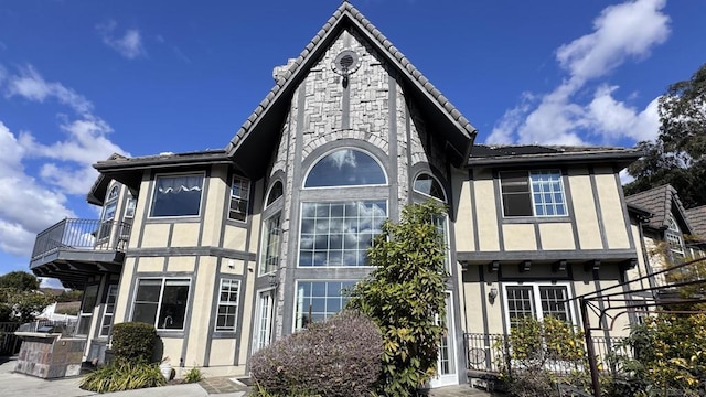 tudor-style house featuring a balcony