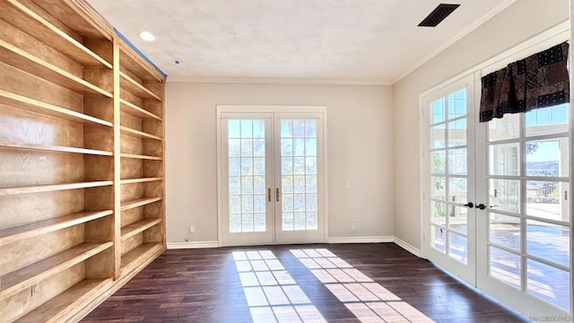 doorway with crown molding, dark hardwood / wood-style floors, french doors, and a healthy amount of sunlight