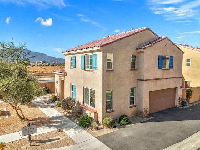 view of front facade featuring a garage and a mountain view