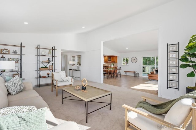 living room featuring light colored carpet and vaulted ceiling