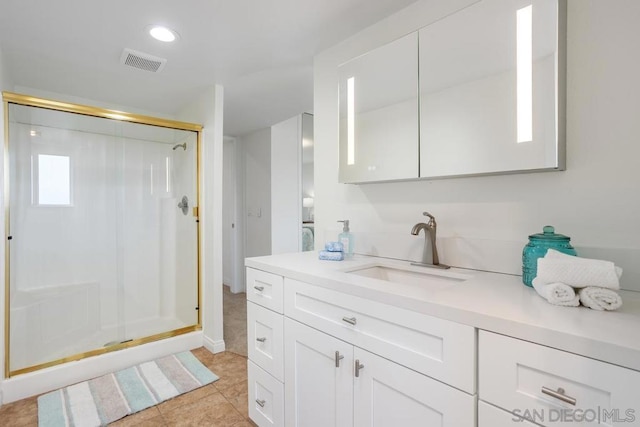 bathroom with vanity, tile patterned flooring, and a shower with door