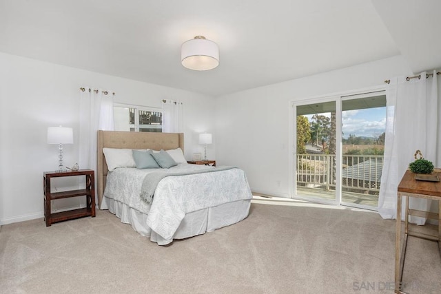 bedroom with access to exterior and light colored carpet