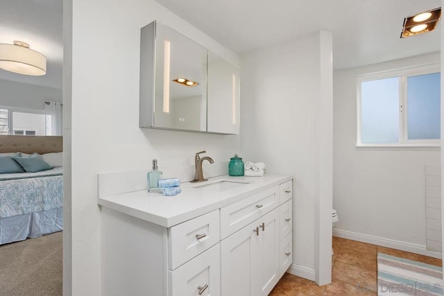 bathroom with vanity, toilet, and tile patterned flooring