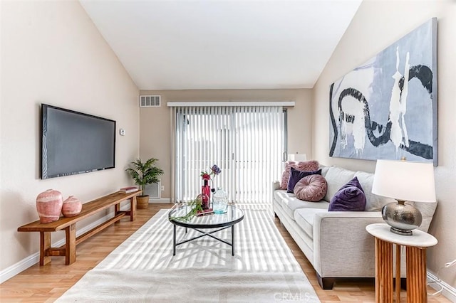 living room with lofted ceiling and wood-type flooring