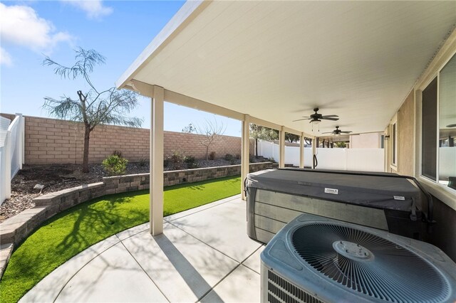 view of patio featuring a hot tub, ceiling fan, and central air condition unit