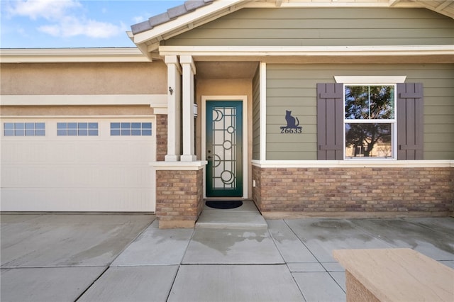 view of exterior entry with a garage