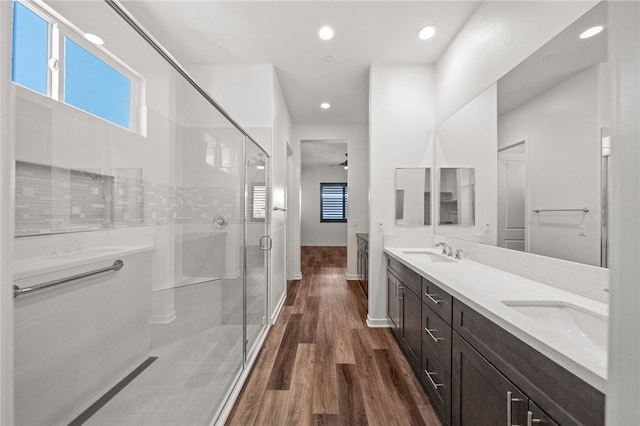 bathroom with vanity, hardwood / wood-style flooring, and a shower with shower door