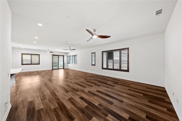 unfurnished living room featuring dark hardwood / wood-style flooring and ceiling fan