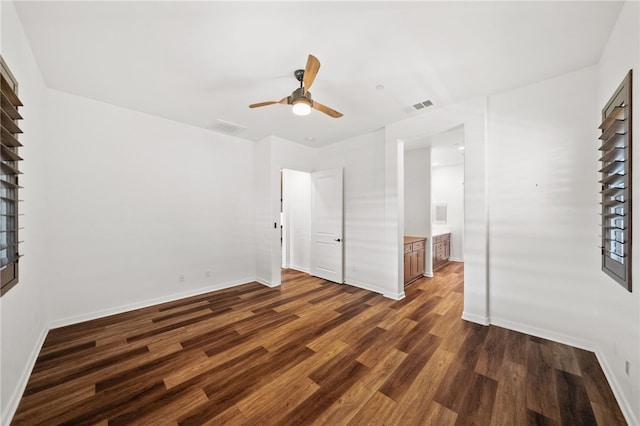 unfurnished bedroom featuring dark wood-type flooring, ceiling fan, and ensuite bathroom