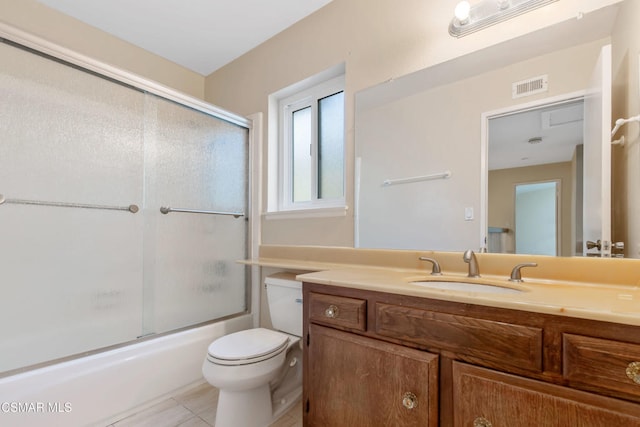 full bathroom with vanity, toilet, tile patterned flooring, and combined bath / shower with glass door