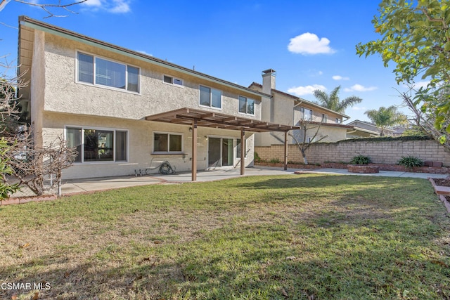 back of property featuring a yard, a patio area, and a pergola