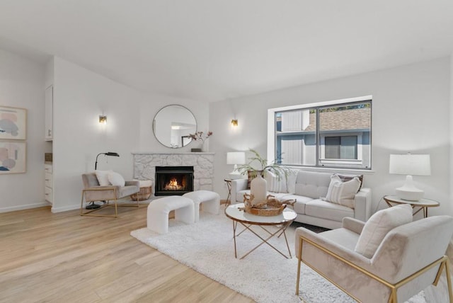 living room with light wood-type flooring and a fireplace