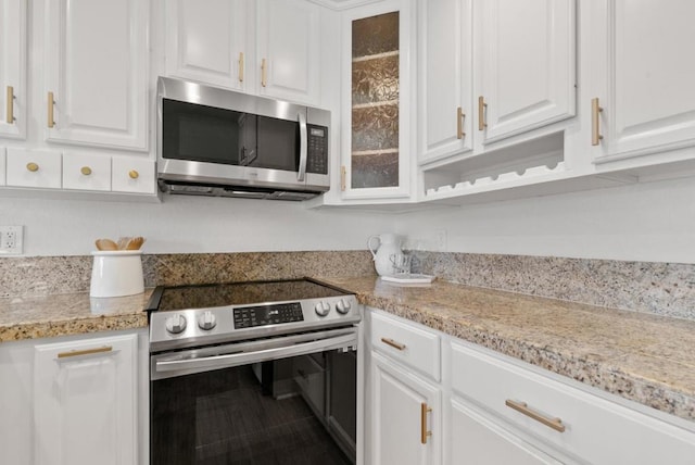 kitchen with white cabinets and appliances with stainless steel finishes