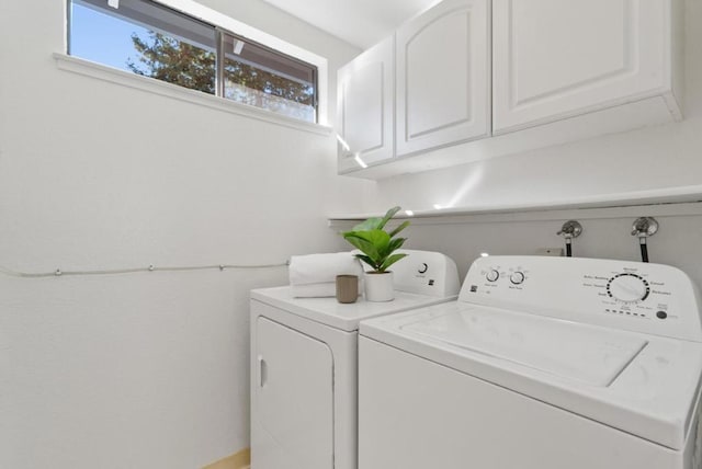 laundry room featuring cabinets and washing machine and clothes dryer