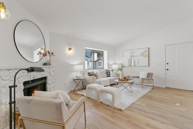 living room with vaulted ceiling and light hardwood / wood-style flooring