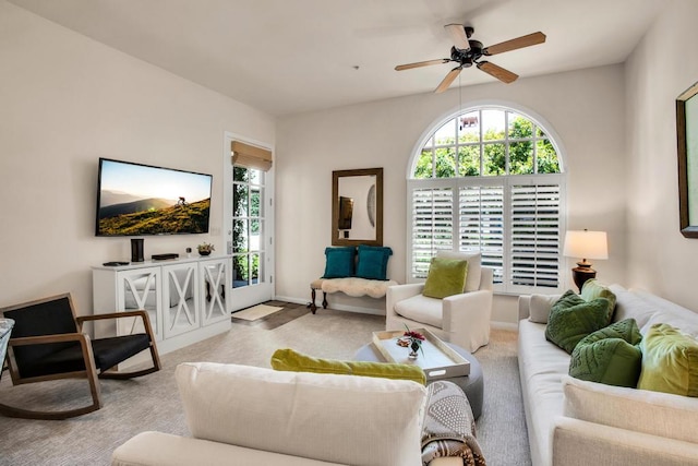 carpeted living room with ceiling fan