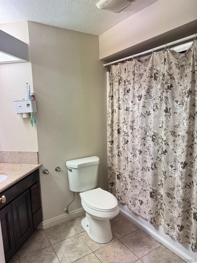 full bathroom with vanity, a textured ceiling, tile patterned floors, and toilet